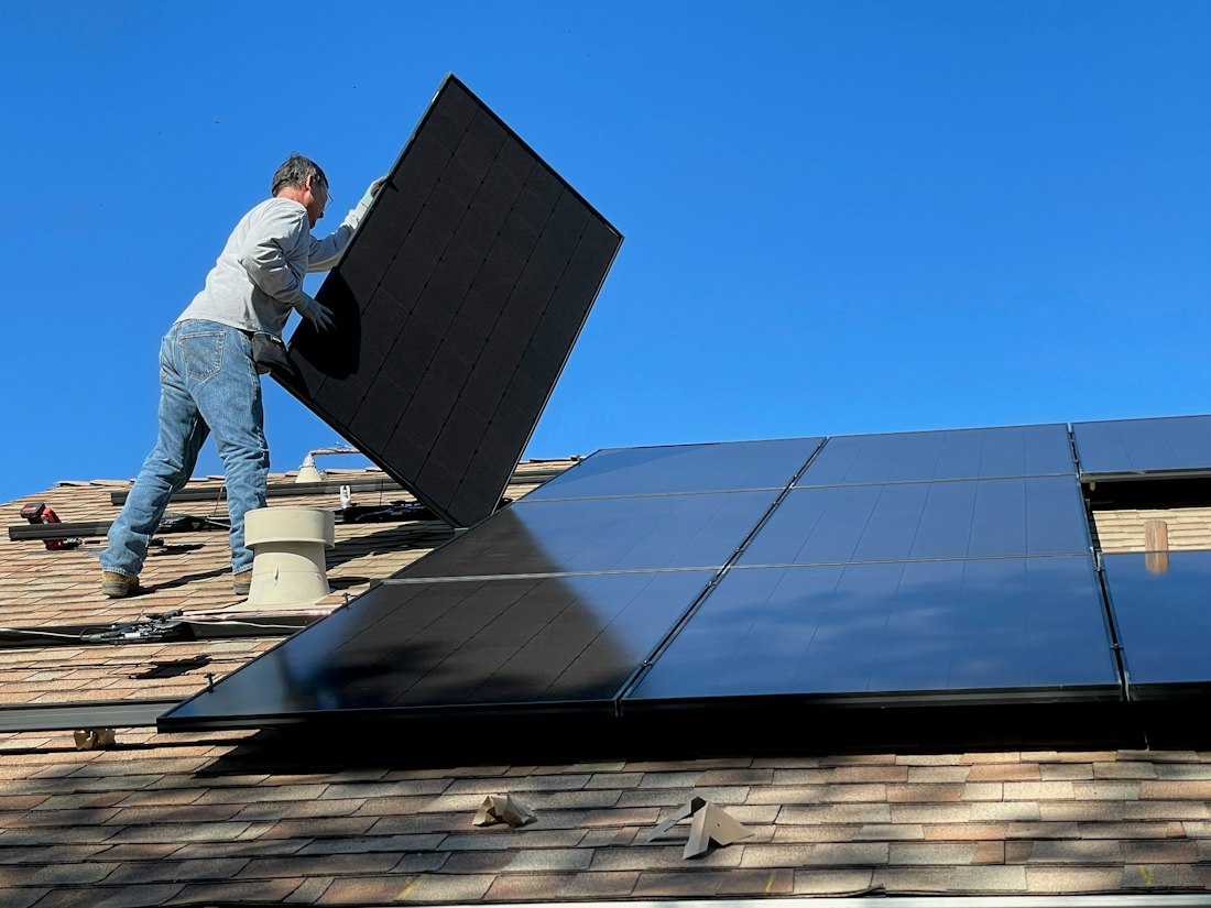 Technician installing a solar panel